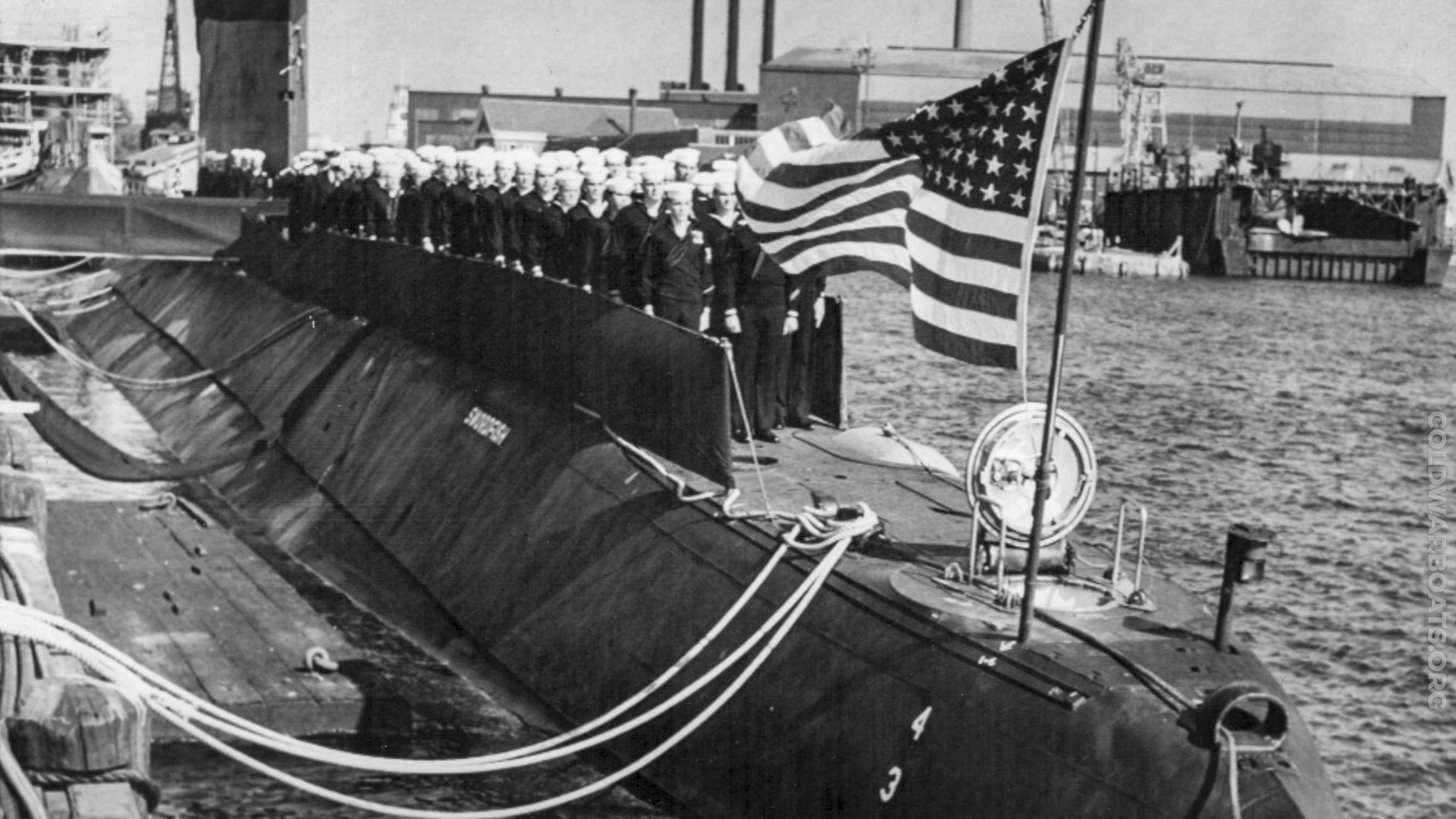The ship's company topside on the USS SWORDFISH (SSN 579) during commissioning ceremonies at Portsmouth Naval Shipyard, 15 SEP 1958.