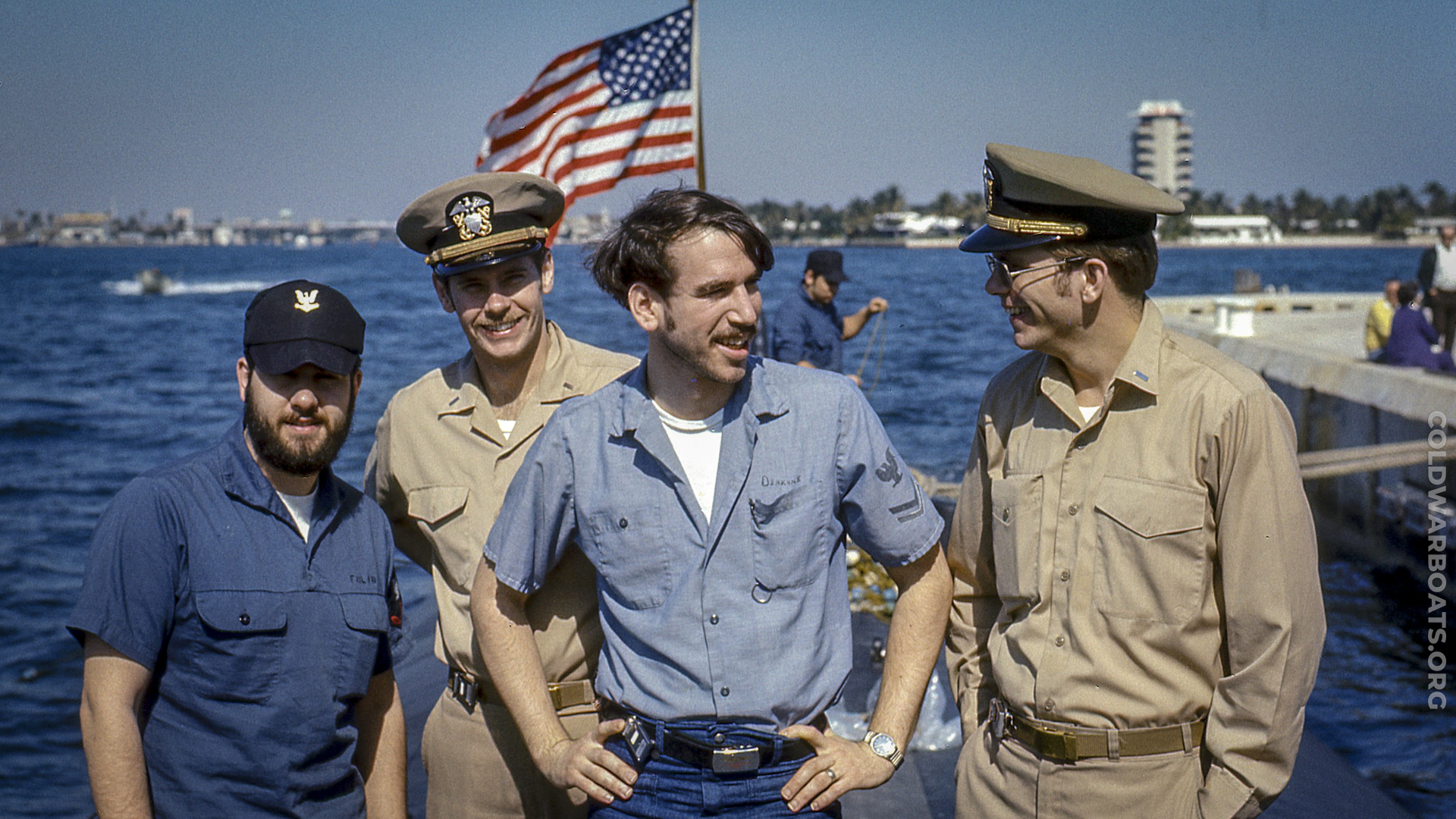 USS WILLIAM H. BATES (SSN 680) - ETR2(SS) Curt Folio, LTJG Jeff Griffiths, ETR2(SS) Ken Deakyne, and LTJG John Dempsey find something to smile about on a bright Ft. Lauderdale morning prepping for public visitor tours ~ 1976 (Neal Degner)